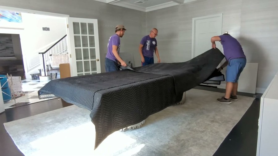 An All Aboard Movers crew carefully carrying a piece on a San Antonio job
